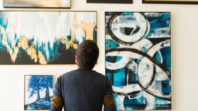 A man observing artwork in a gallery.