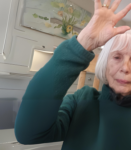 An older woman raising her hand