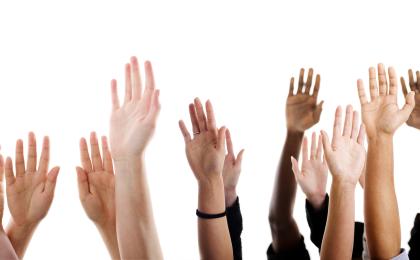 Image of hands reaching up into the air